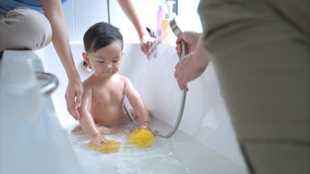 Happy time for bath, Asian kid and parents enjoying bath in the bathroomの写真素材