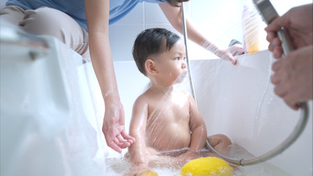 Happy time for bath, Asian kid and parents enjoying bath in the bathroomの写真素材