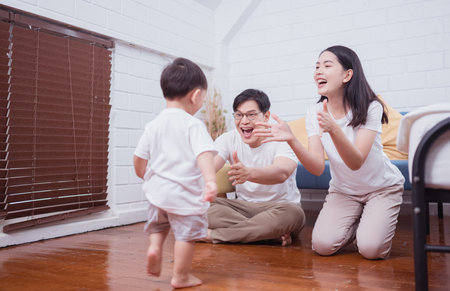 Before putting the kids to bed, parents, and kid unwind and play in the bedroomの写真素材