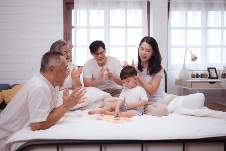 Before putting the kids to bed, parents, grandparents, and kid unwind and play in the bedroom