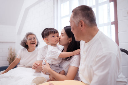 Before putting the kids to bed, parents, grandparents, and kid unwind and play in the bedroom