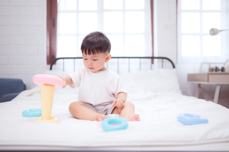 Before putting the kids to bed, kid unwind and play with toy in the bedroomの写真素材