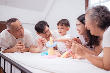 Before putting the kids to bed, parents, grandparents, and kid unwind and play in the bedroom