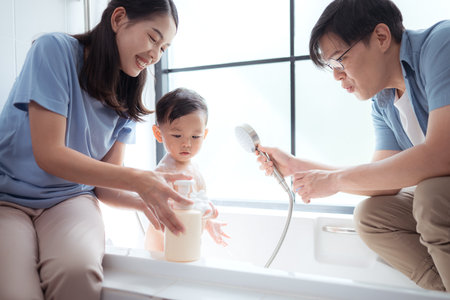 Happy time for bath, Asian kid and parents enjoying bath in the bathroomの写真素材