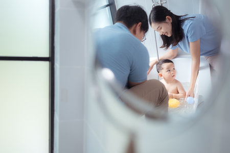 Happy time for bath, Asian kid and parents enjoying bath in the bathroomの写真素材
