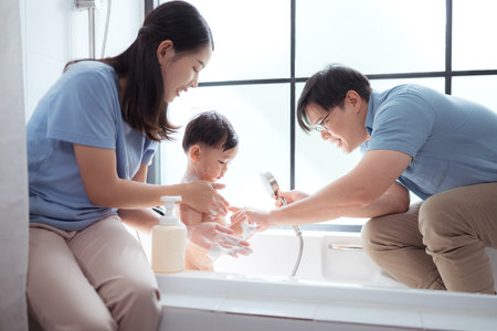 Happy time for bath, Asian kid and parents enjoying bath in the bathroomの写真素材