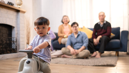 Happy multi-generational Asian family enjoying quality time together at home, cheering and smiling...