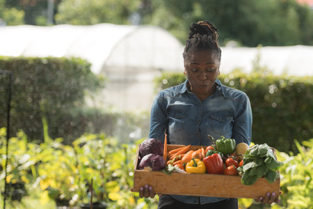 Portrait of woman with a tray of fruit and vegetable, enjoying a day of learning and gardening...