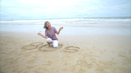 Portrait of senior women enjoying a playful walk on the beach, happy as they splash through the...