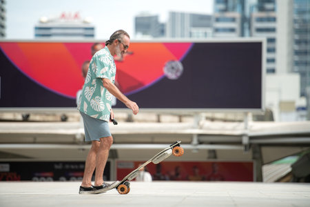 Senior man riding an electric skateboard in the city, enjoying urban lifestyle with modern...