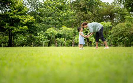 Father and daughter enjoying picnic in the park, Creating joyful outdoor lifestyle momentの写真素材