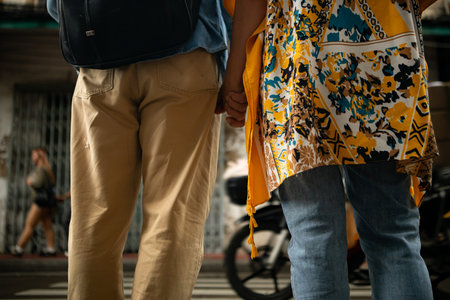 Happy senior couple walking on a city street, holding hands and sightseeing together, enjoying travel and urban lifestyleの写真素材