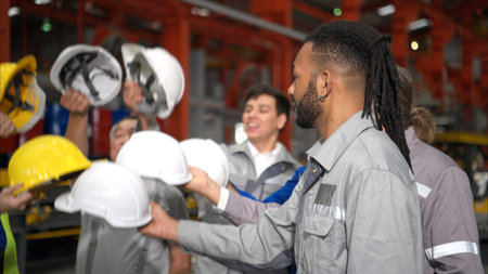 Group of Industrial worker inspecting inside a large metal tube in a factory wearing safety helmet
