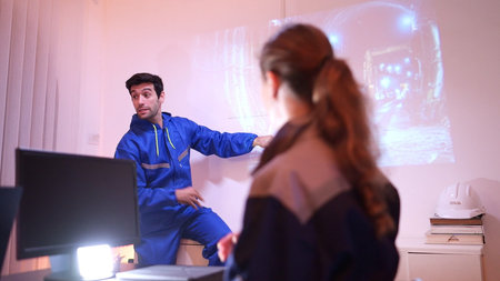 Engineers and industrial workers in safety uniforms discussing a tunnel construction project in a...