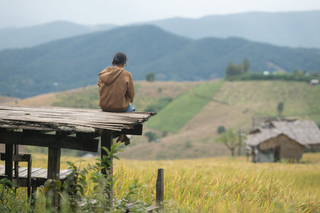 Woman standing with open arms on a wooden platform, embracing freedom, wellness, and mindful travel in natureの写真素材