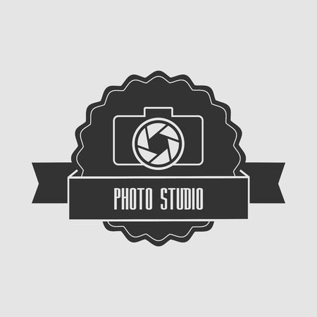 Concept logo photo studio. The camera lens and with the words "Photo Studio" on the tape. Can be used to design business cards, posters, posters; decorating shop windows and signageのイラスト素材