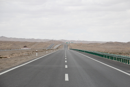 Empty long road in the desertの写真素材