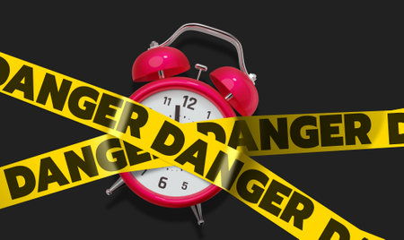 3d illustration of red retro alarm clock with arrow and crossed yellow ribbon with word deadline on black color backgroundの写真素材