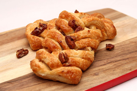 Apple and Pecan plait danish pastry on wooden boardの写真素材