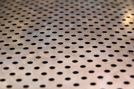 Metal texture pattern with holesの写真素材