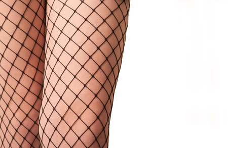 Female legs in fishnet stockings isolated over white