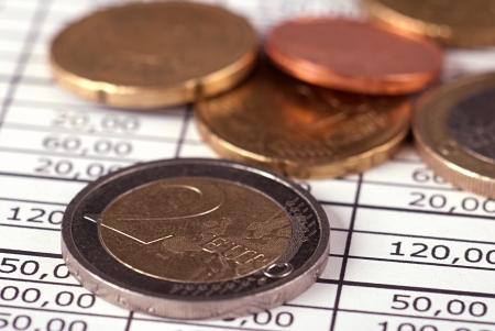 Euro coins arranged on a financial statementの写真素材
