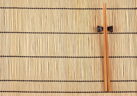 Chopsticks lying on a bamboo matの写真素材