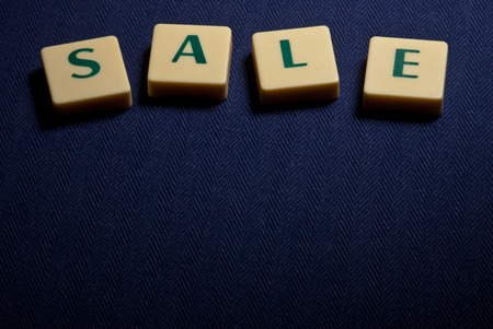 Sale word made of plastic letters on dark blue backgroundの写真素材