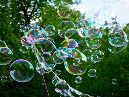 Multicolored big soap bubbles outdoors - natural backgroundの写真素材