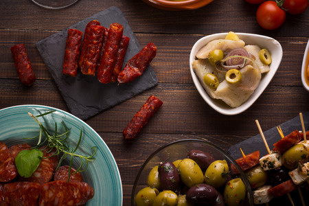 Top view of variety of mediterranean starters - spanish tapas with chorizo and olivesの写真素材