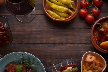 Top view of variety of mediterranean starters - spanish tapas with shrimps and pepper with copy spaceの写真素材