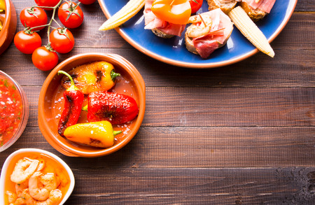 Variety of Mediterranean snacks on old wooden table. Tapas or antipasti. Copy spaceの写真素材
