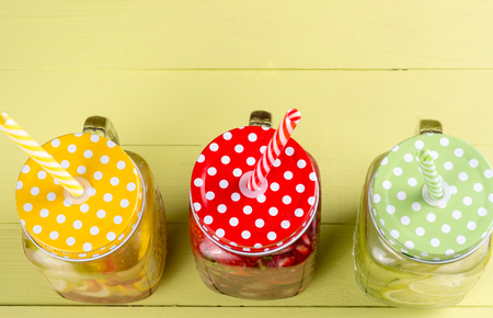 Fresh fruits flavored water healthy detox drinks in jars - top viewの写真素材