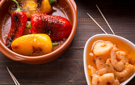 Variety of Mediterranean snacks on old wooden table. Tapas or antipasti. Top viewの写真素材