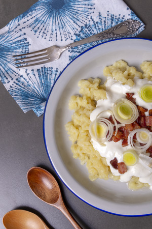 Bryndzove halusky. Traditional Slovak dish - potato dumplings with fried bacon, sheep cheese and sour cream.の写真素材