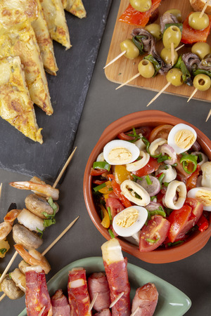 Top view of Spanish tapas snacks with olives, anchovies and peppersの写真素材