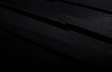 Black abstract background made of dark fabric with fine cavitiesの写真素材