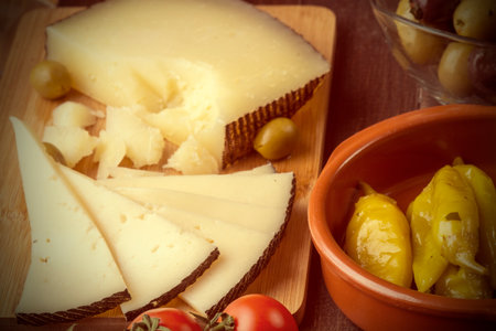 Variety of Mediterranean snacks on old wooden table. Tapas or antipasti. Vintage effectの写真素材