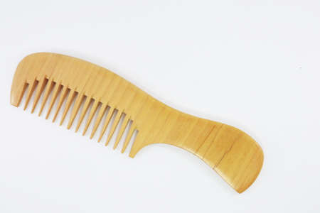 Comb for styling hair Material made of wood on a white background, For reducing global warming and plastic waste problems.の写真素材