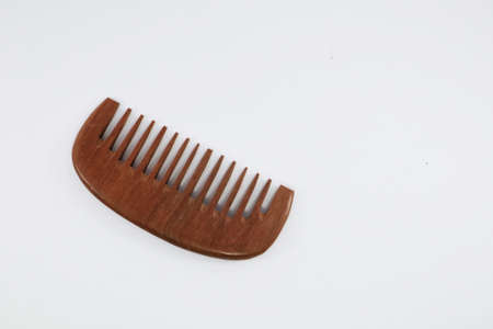 Comb for styling hair Material made of wood on a white background, For reducing global warming and plastic waste problems.の写真素材
