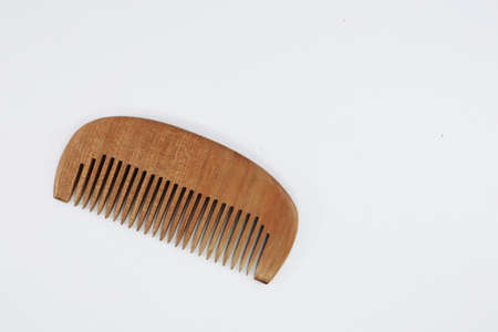 Comb for styling hair Material made of wood on a white background, For reducing global warming and plastic waste problems.の写真素材