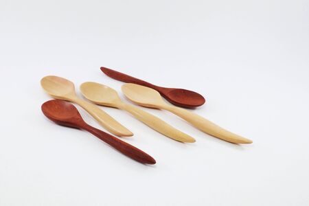 Spoon and fork made of wood, used in kitchen and decorationの写真素材