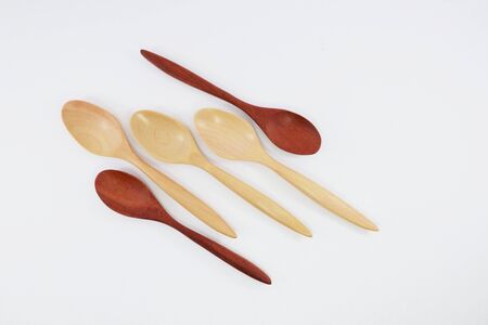 Spoon and fork made of wood, used in kitchen and decorationの写真素材