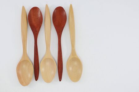 Spoon and fork made of wood, used in kitchen and decorationの写真素材