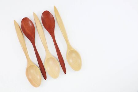 Spoon and fork made of wood, used in kitchen and decorationの写真素材