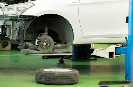 Car brakes with wheels that have been removed and parts removed for repair. There are rubber shock...