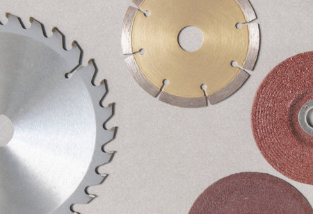Blur circular saw blades for wood have teeth of serrated blades all around and concrete cutting disc with Red brown steel grinding wheels . Four-inch brown-red steel cutting blades placed on the background All are industrial equipment.の写真素材