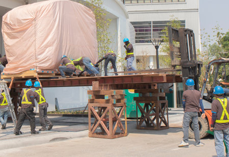Train head, covering the pink cloth moving by worker pushing from orange forklift is lifting,...
