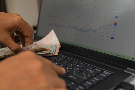 Top view hand put on baknote and black keyboard on notebook have and a memory card plugged into computer on white background have space for text. business online concept, make money online next generation.の写真素材