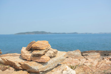 Rock on the rocks seen from above, the mountain has blue sea, island and sky as background. Eco tourism concept.の写真素材